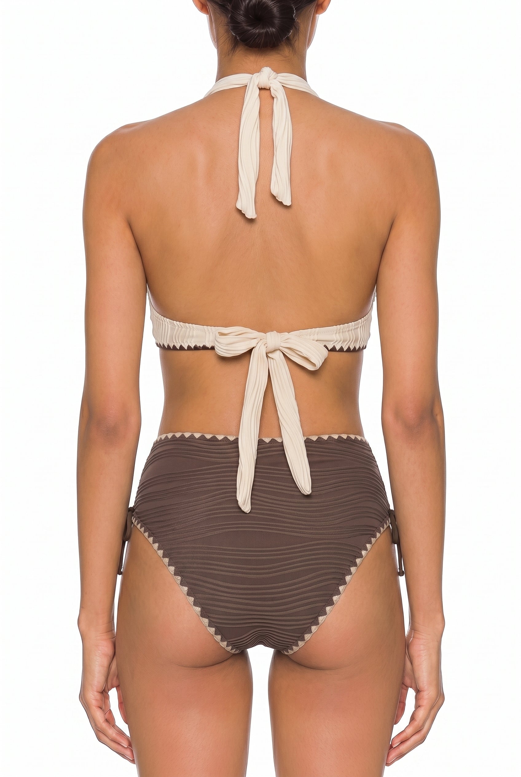 Back view of cream halter bikini top tied at neck and back with brown striped bikini bottoms on white background