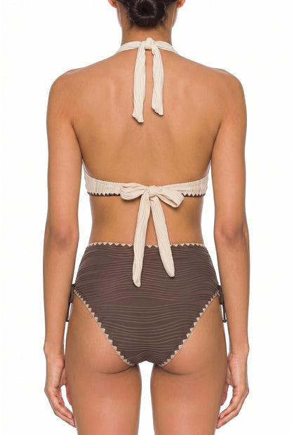 Back view of cream halter bikini top tied at neck and back with brown striped bikini bottoms on white background